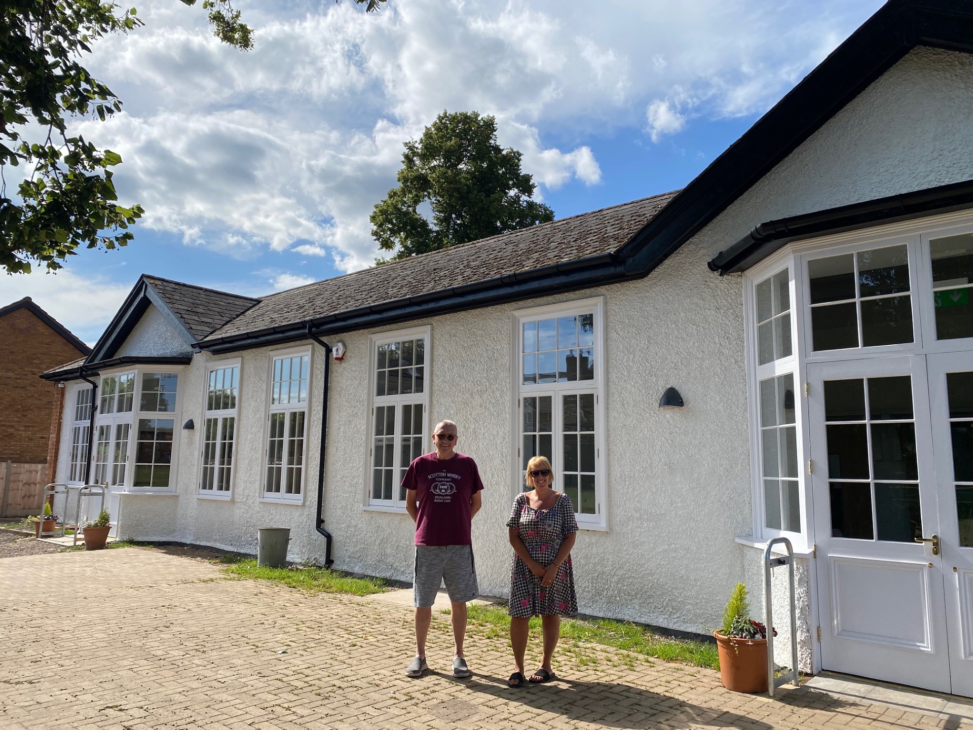 Two people standing outside a building
